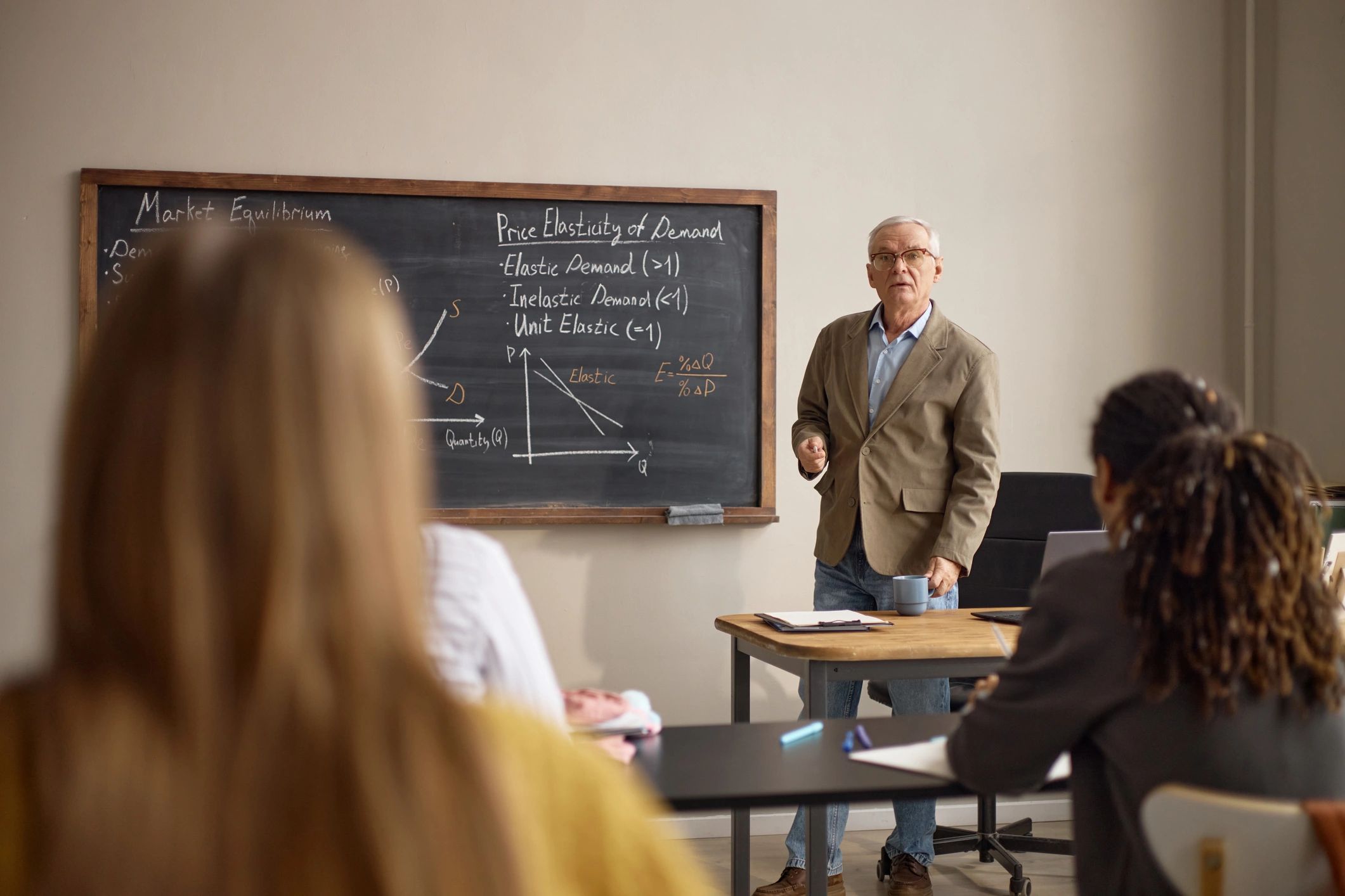 Instructor teaching an economics lesson in a classroom